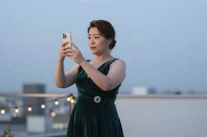 夜景をスマホで撮影する女性