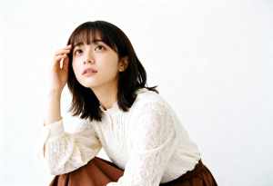 真っ白な背景のフレームの中央に座って、思慮深い表情をした若い女性の写実的なポートレート。