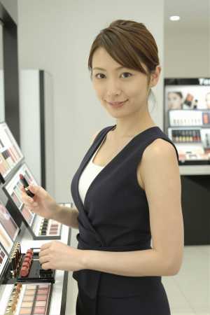コスメカウンターで口紅を選ぶ女性