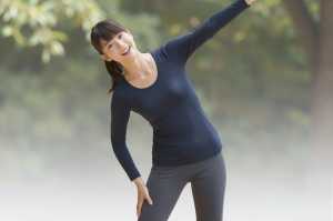 公園でストレッチするリラックスした女性