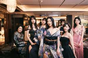 豪華なホテルのロビーで写真を撮る7人の女性グループ。