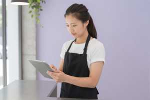 モダンカフェでメニューを確認するスタッフ