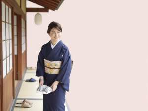 旅館の玄関で履物を整える女性