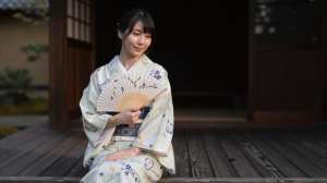 旅館の縁側で夕涼みする女性