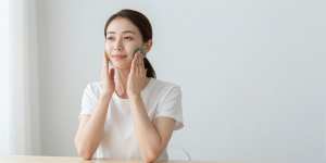 寝室でグアシャマッサージをする女性