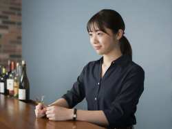 バーのカウンターで微笑む女性ポートレート