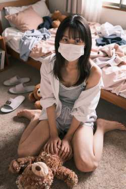 マスクを被った若き女性の室内ポートレート