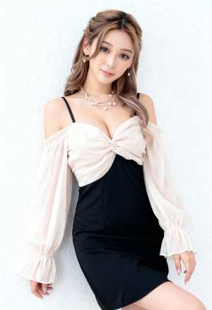 正面に結び目のディテールが施された黒とクリーム色のオフショルダー ドレスを着て、真珠...。