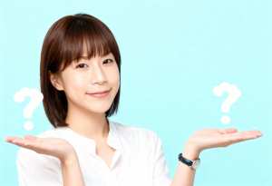 頭の上に疑問符が付いた空の手を差し出しているアジア系の若い女性を正面カメラのアングル...。