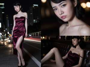 豪華なワインレッドのサテンのドレスを着た女性が夜の街路で自信を持ってポーズをとる、正...。