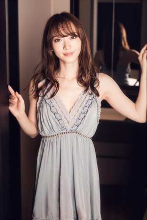 水色のドレスを着てガラスのドアの前に立ってポーズをとる若い女性を、ポートレート カメ...。