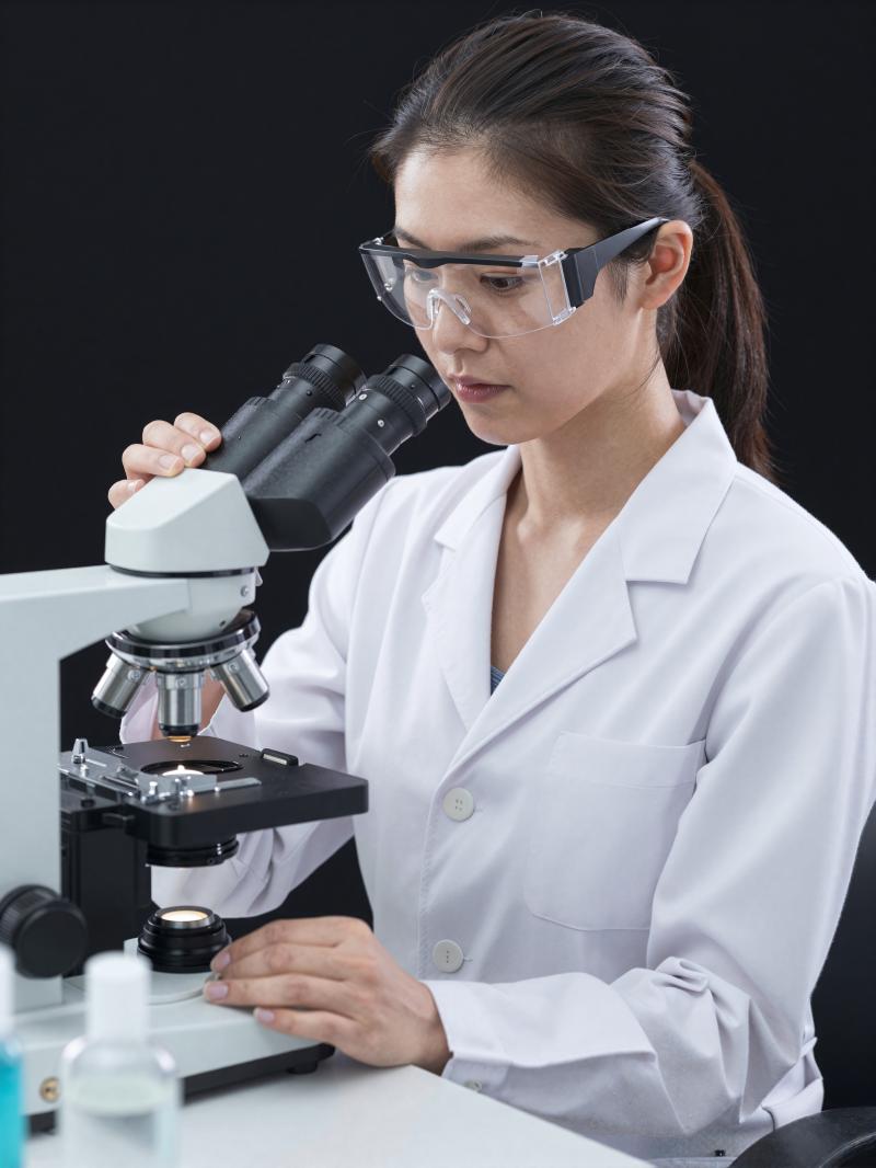 化粧品研究所で顕微鏡を使う研究員