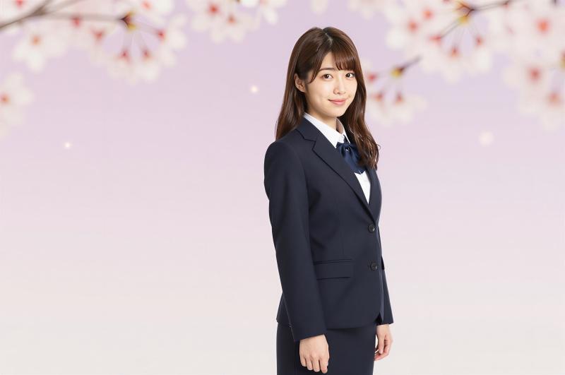 桜の背景で微笑む女性ポートレート写真