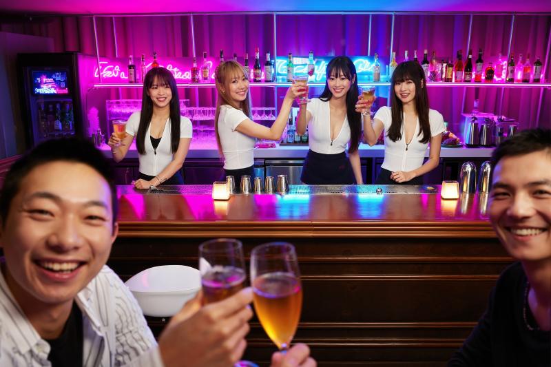 ネオン輝くバーのバーカウンターでドリンクを楽しむ 5 人のアジア人の若者のグループを...。