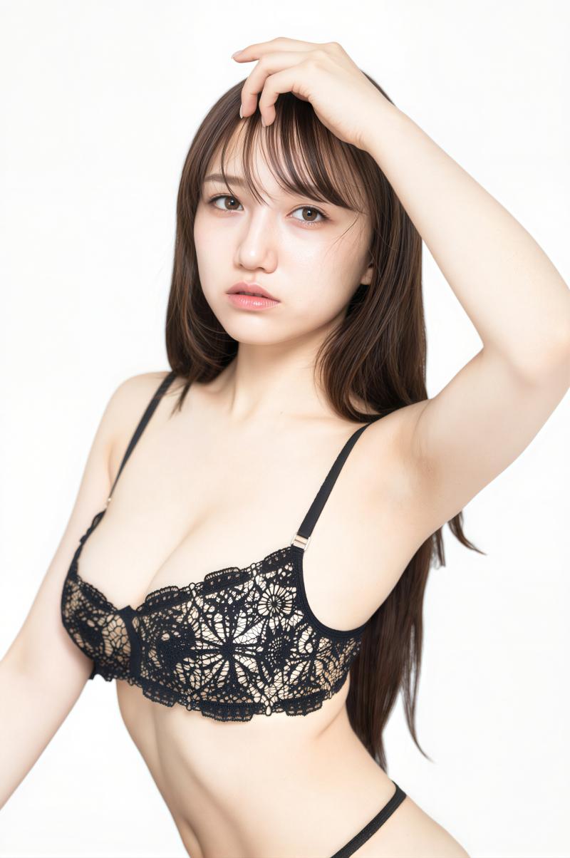 黒いレースのブラジャーとパンティーを着てポーズをとる若い女性をポートレートアングルか...。